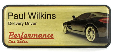 A dark border prestige name badge brushed design with golden background with the leyend: "Paul Wilkins"